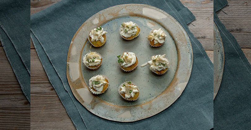 Savoury courgettes cupcakes with topping of cheese and sweet gorgonzola cream, almonds and marjoram 