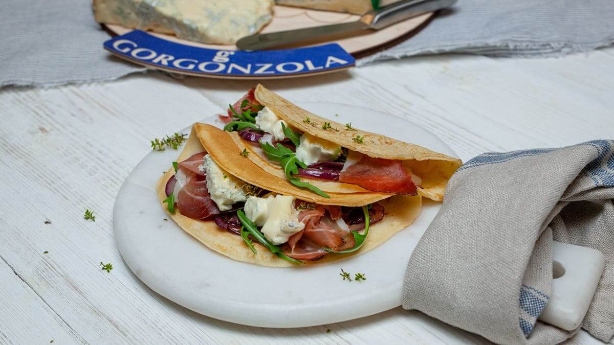 Crepes filled with sweet Gorgonzola PDO, caramelised onions, speck and herbs - Gorgonzola DOP